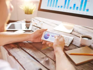a man is looking at a pie chart on his phone
