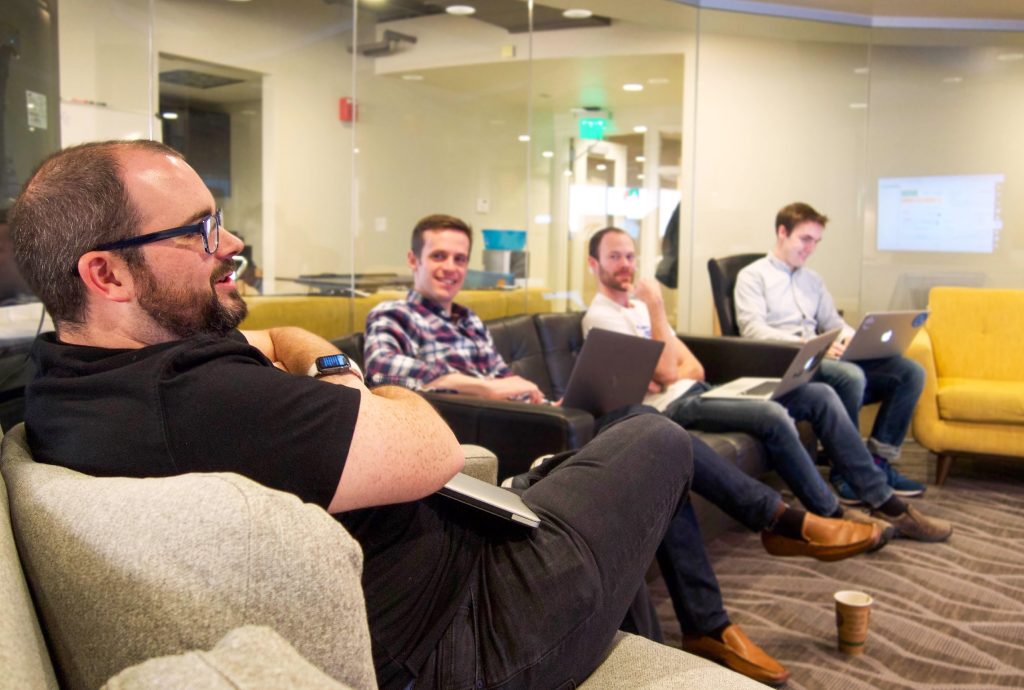 a group of Nutshellers sit on a couch with laptops