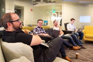 a group of Nutshellers sit on a couch with laptops