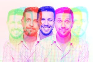 a man with a beard is surrounded by a rainbow of colors