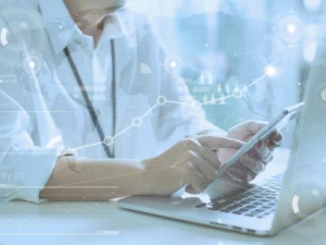 a person is using a laptop and a cell phone with a graph behind them that says analytics