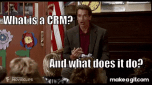 a man in a suit is talking to a group of children and asks "what is a CRM, and what does it do?"