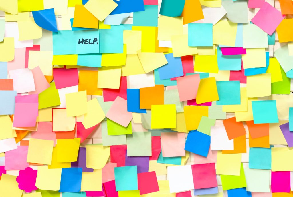 a bunch of sticky notes with one that says help