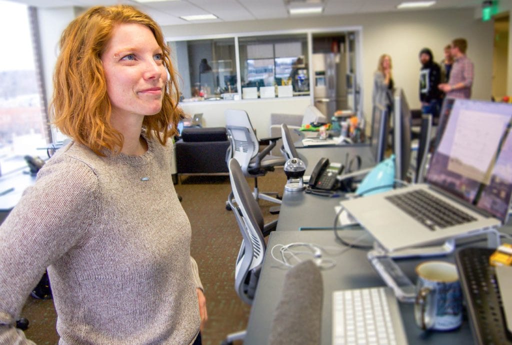 a Nutshell team member stands in front of a desk with a laptop on it