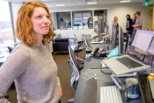 a Nutshell team member stands in front of a desk with a laptop on it