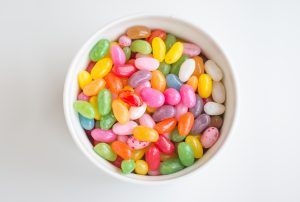 a white bowl filled with many different colored jelly beans