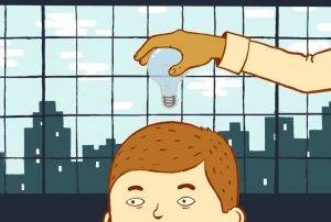 a hand is holding a light bulb over a man's head
