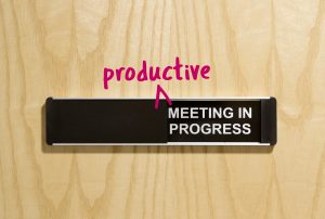 a wooden door with a sign that says Productive meeting in Progress