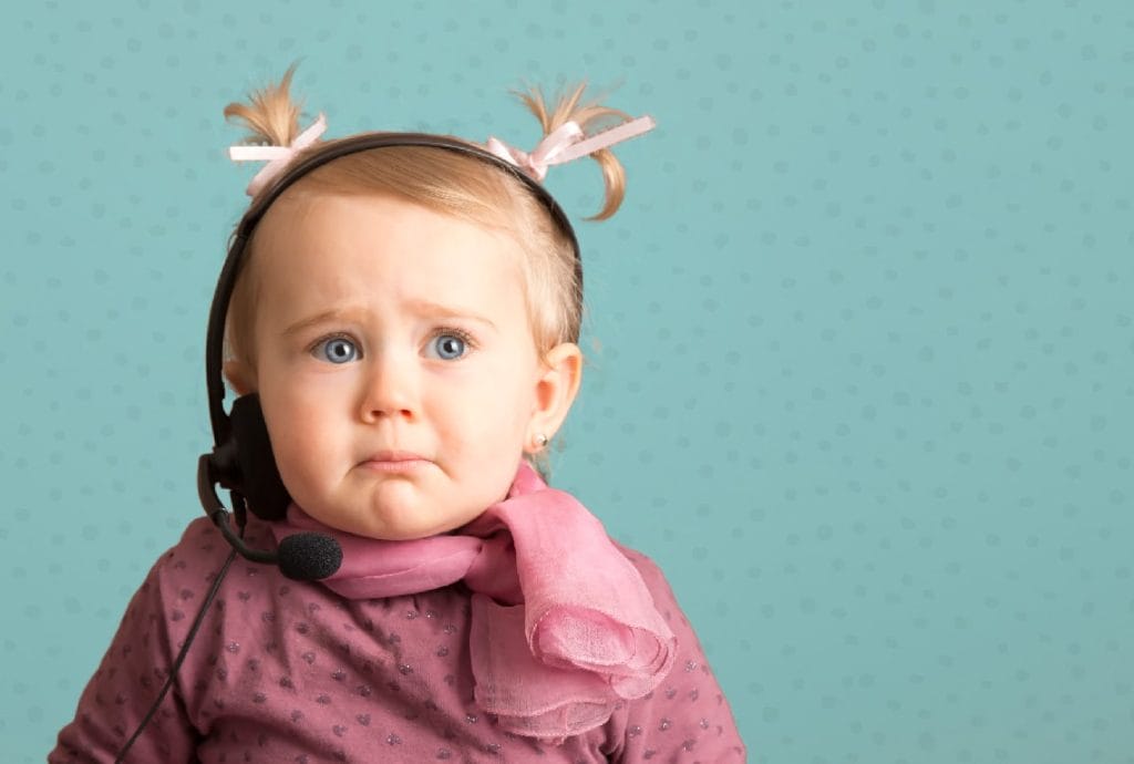 a little girl wearing a headset and scarf looks sad