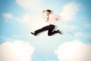 a man in a suit and tie is jumping in the air