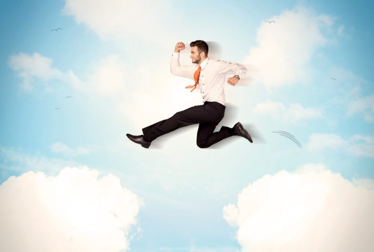 a man in a suit and tie is jumping in the air