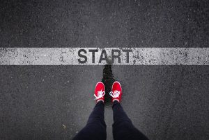 a person wearing red shoes is standing at the start line