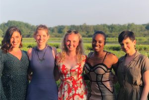 five Nutshellers standing together in a field