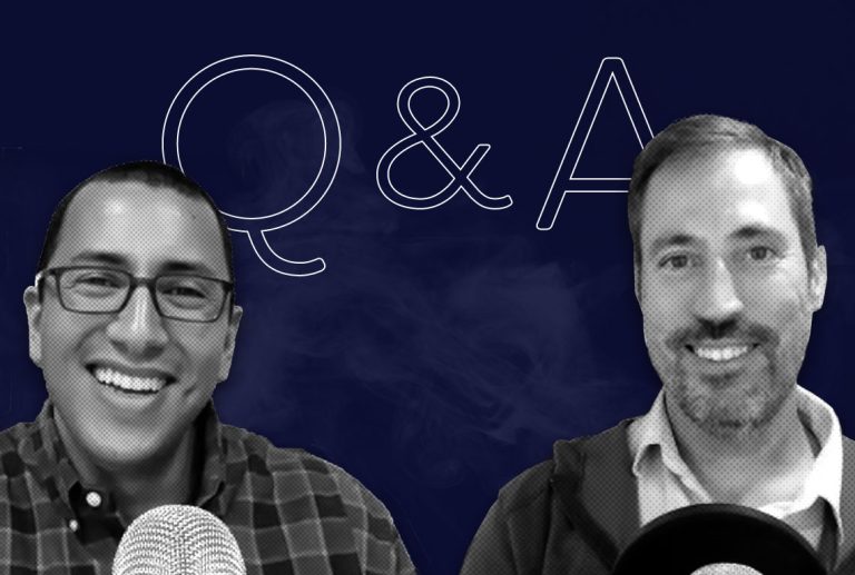 ben goldstein and brian carroll are sitting next to each other in front of microphones .