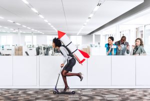 a woman is riding a scooter with a rocket on her back