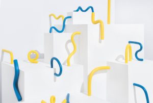 a bunch of blue and yellow pipes are sitting on white blocks