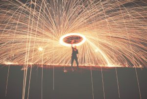 a person is spinning fireworks above him