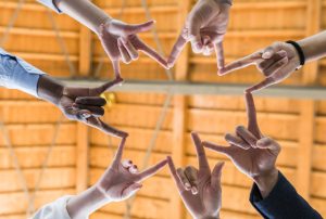 a group of people are making a star shape with their hands