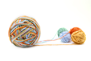 a ball of yarn is surrounded by other balls of yarn