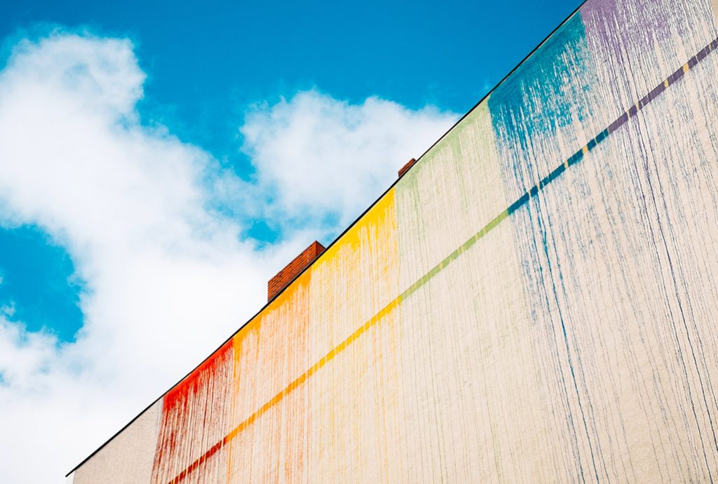 a building with a rainbow of colors painted on it