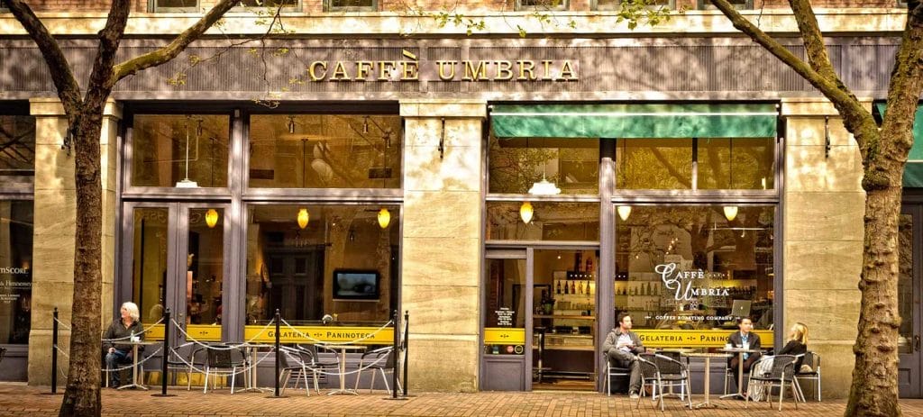 people sit at tables outside of Caffe Umbria