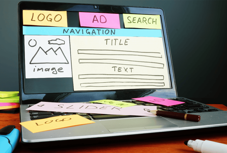 A laptop with sticky notes on it that say logo, ad, search, and navigation.