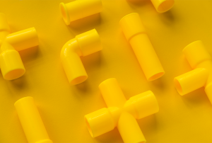 a bunch of yellow plastic pipes on a yellow background