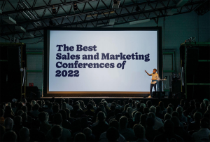 a man giving a presentation at the best sales and marketing conferences of 2022