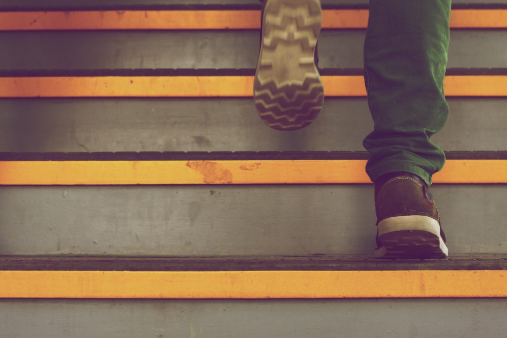a person's feet walking up a set of stairs
