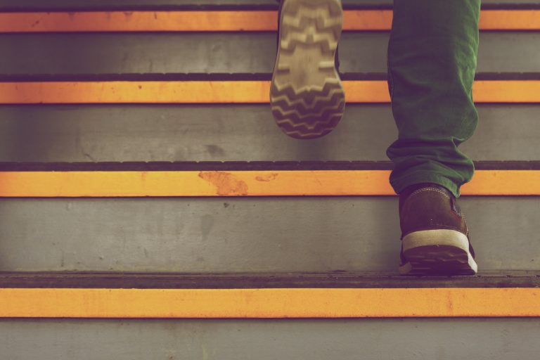 a person's feet walking up a set of stairs