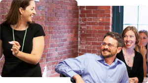 a group of people sitting in front of a brick wall