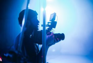 a man is holding a canon camera in his hand