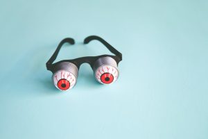 a pair of glasses with red eyes on them