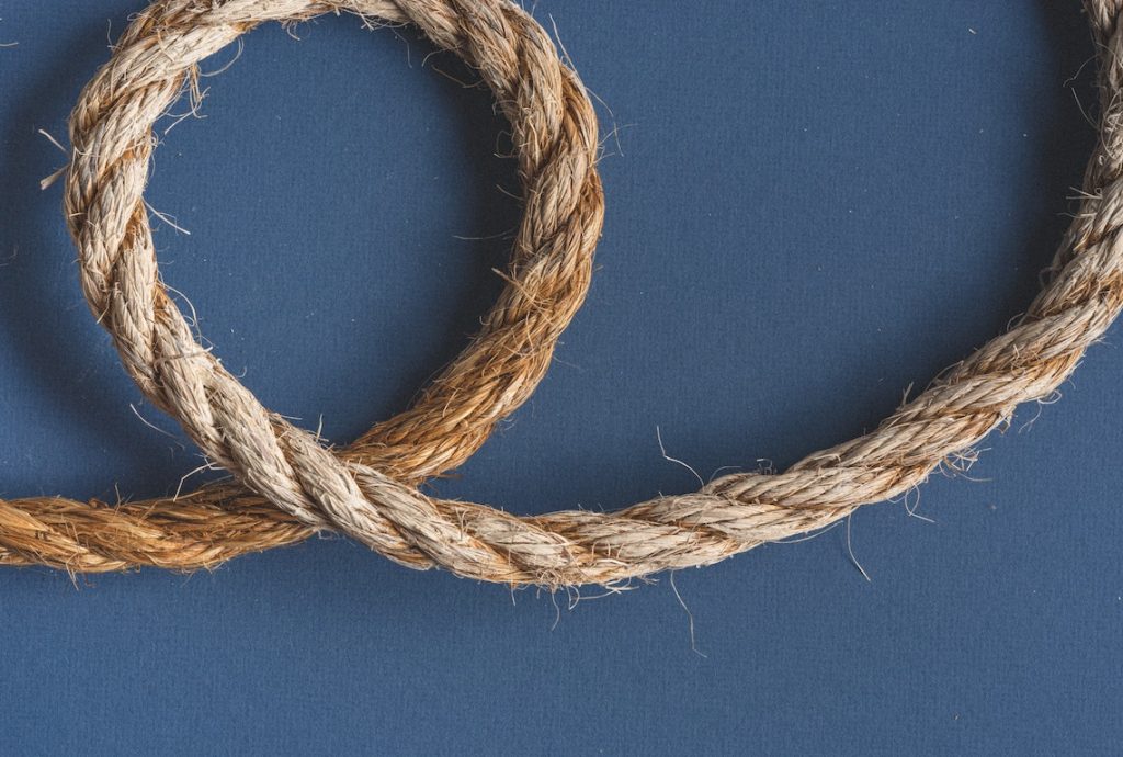 a rope is curled on a blue surface
