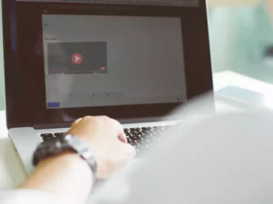 a person is using a laptop with a video on the screen