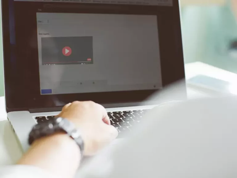 a person is using a laptop with a video on the screen