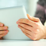 person using tablet to manage and organize customer data