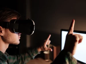 a person wearing a virtual reality headset is pointing upward