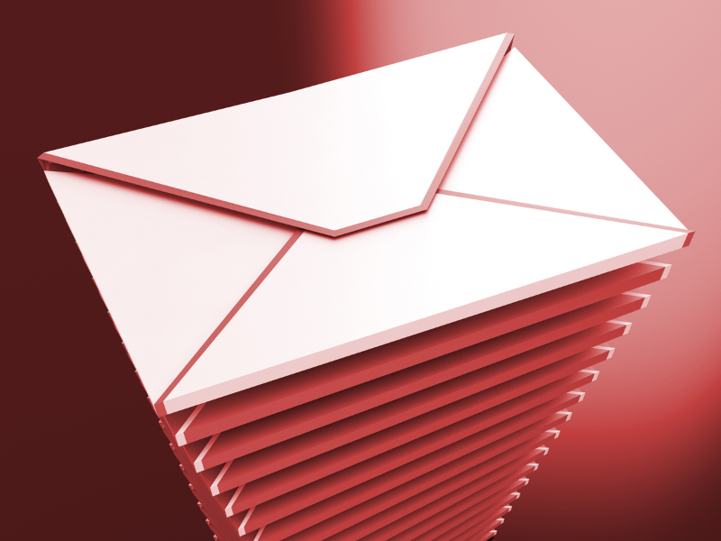 a white envelope is sitting on top of a stack of red envelopes