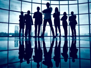 a group of people standing in front of a large window