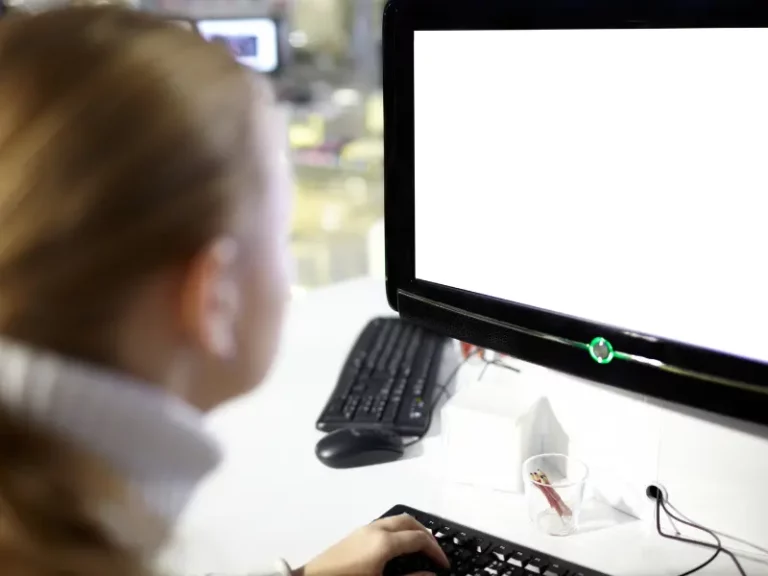 a woman is typing on a computer