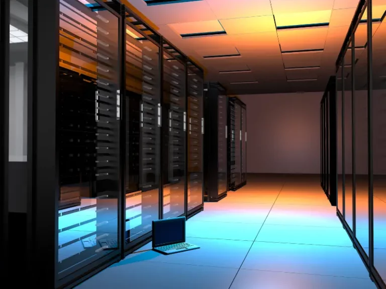 a server room with a laptop on the floor