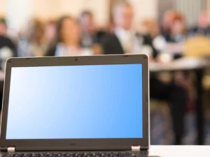 a laptop with a blue screen sits on a table