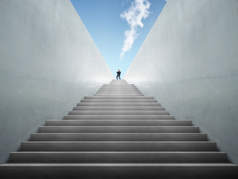 a man stands on top of a set of stairs