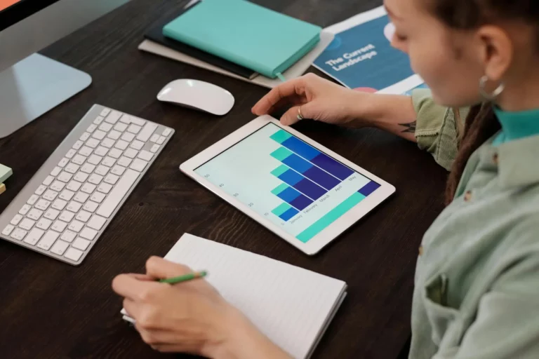 Woman looking at charts on tablet