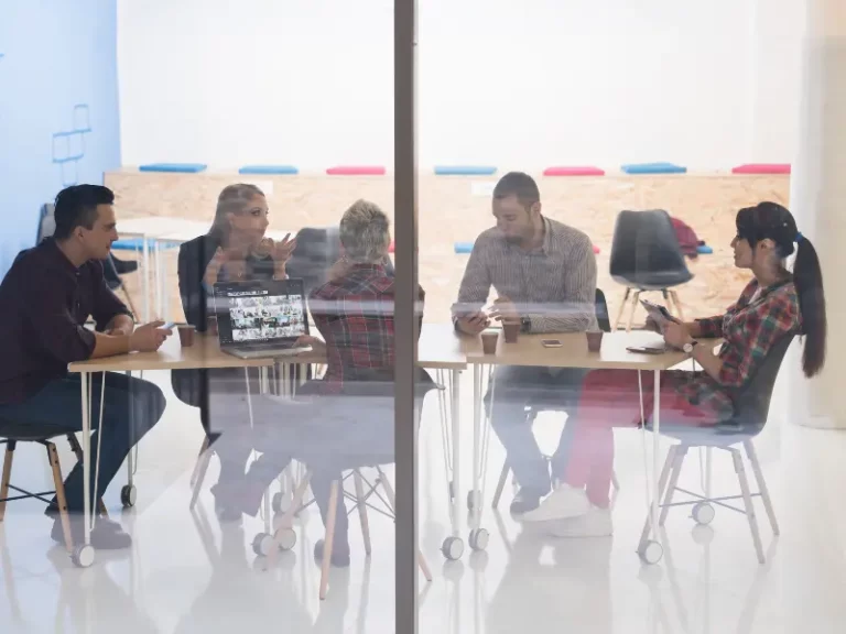 people sitting at a boardroom table having a discussion