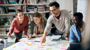 a group of people looking at a board and brainstorming