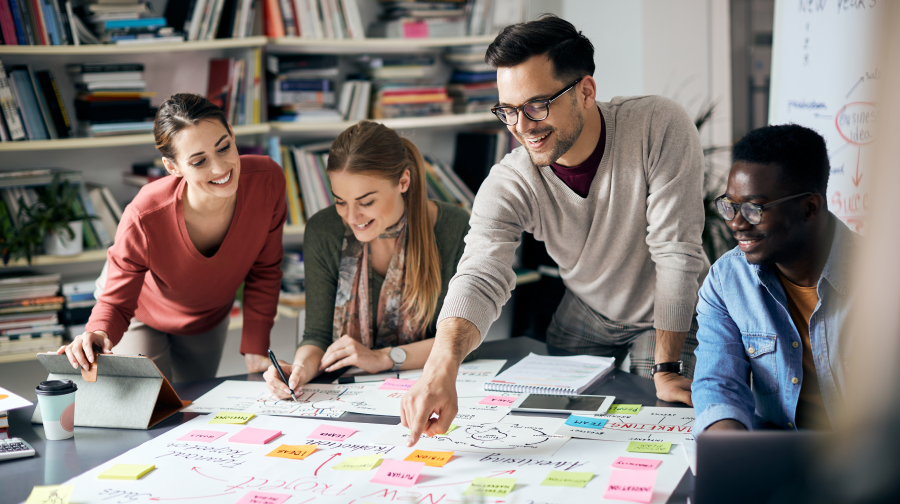 a group of people looking at a board and brainstorming