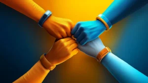 Four hands reach into the center in a team huddle.