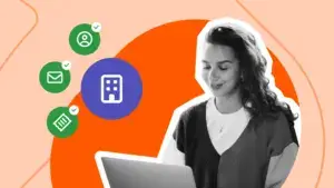 Smiling business owner at a laptop beside icons for company, customer, email, and invoice records marked with green checks